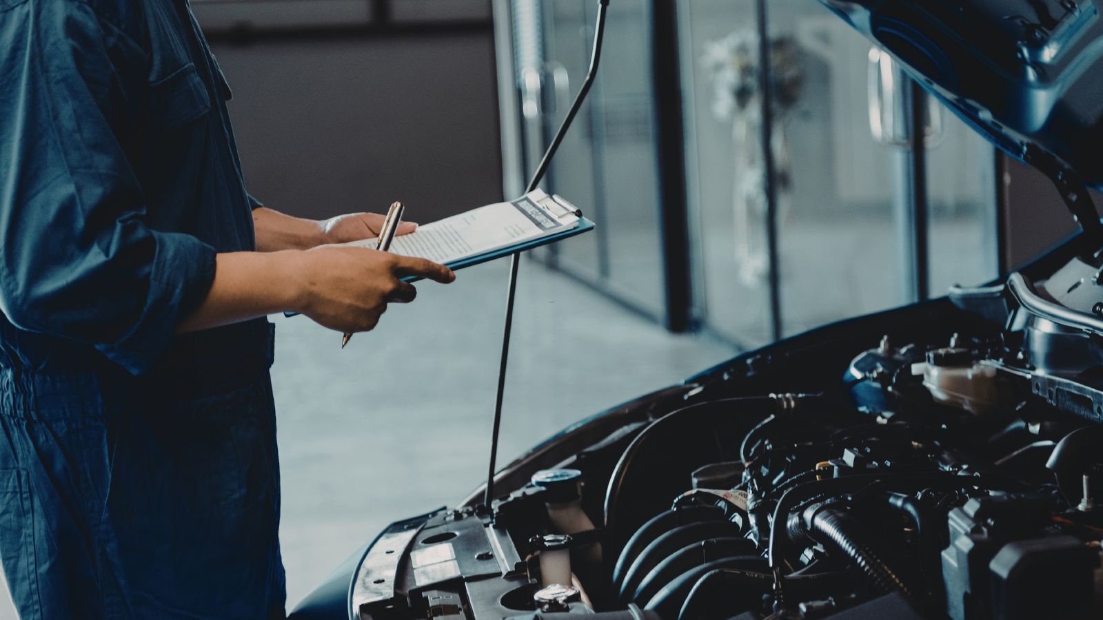Mechanic inspecting car engine