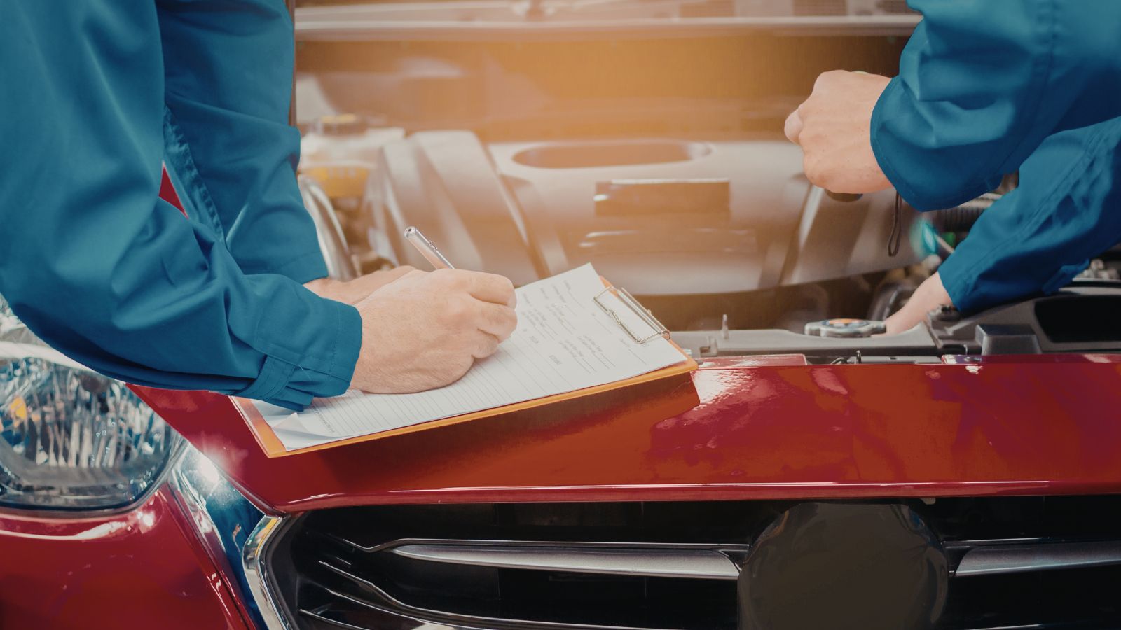 Mechanics inspecting a car